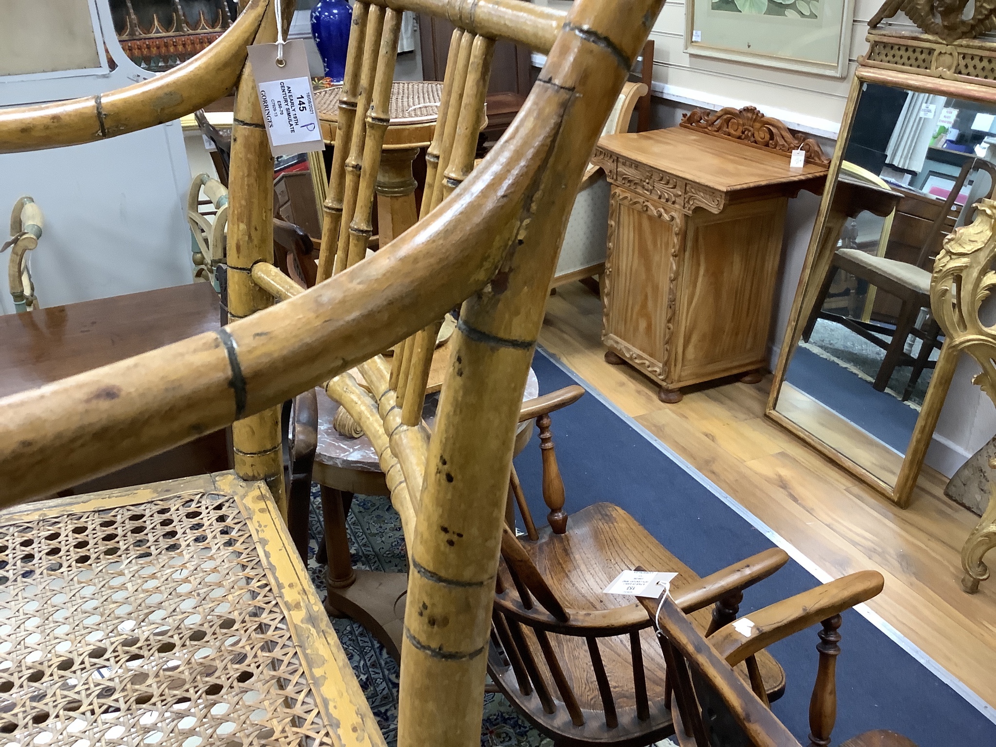 An early 19th century simulated bamboo elbow chair, cane seat